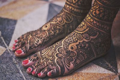 Low section of bride with henna tattoo