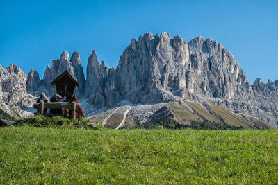 Scenic view of land and mountains against clear sky