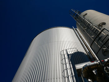 Low angle view of modern buildings against blue sky