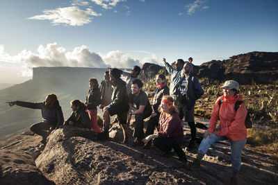 Group of cheerful hikers enjoying on mountain