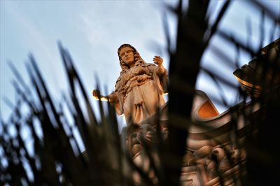 Low angle view of statue against sky