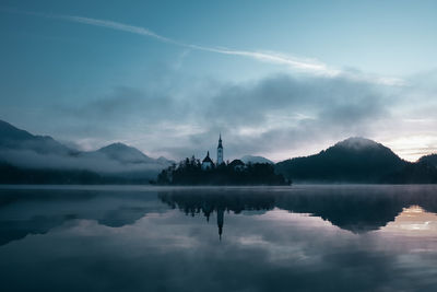 Scenic view of lake against cloudy sky