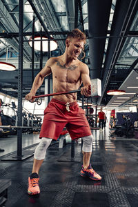 Side view of woman exercising in gym