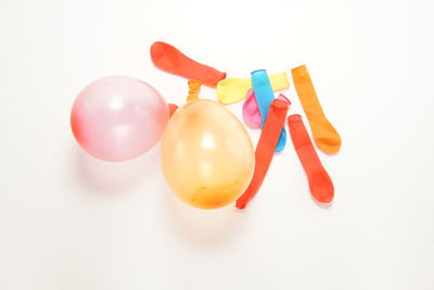 Close-up of multi colored balloons against white background