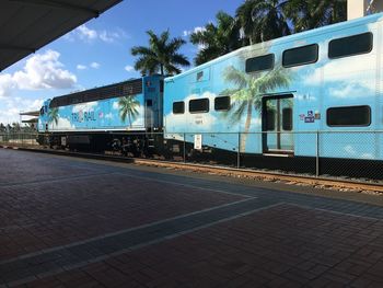 Train at railroad station against sky