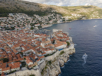 High angle view of buildings by sea