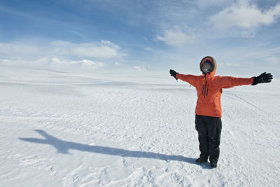 Young woman leaning into the wind on vatnajokull glacier
