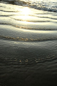 Close-up of sea against sky during sunset