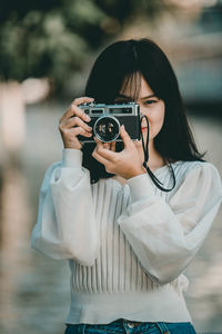 Portrait of woman photographing