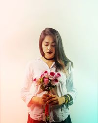 Portrait of woman holding flowers