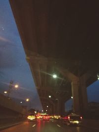 Cars on illuminated street at night