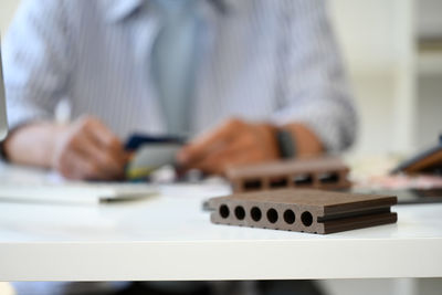 Midsection of businessman working on table