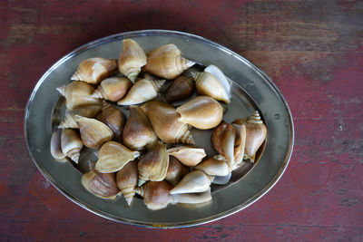 High angle view of escargots in plate on table