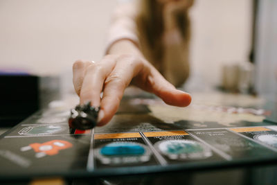 Close-up of woman hand playing board game