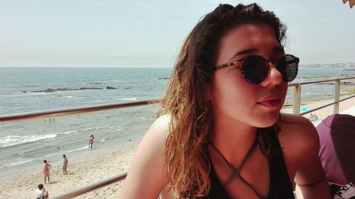 Close-up of young woman in sunglasses at beach