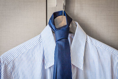 Close-up of shirt and necktie hanging from coathanger