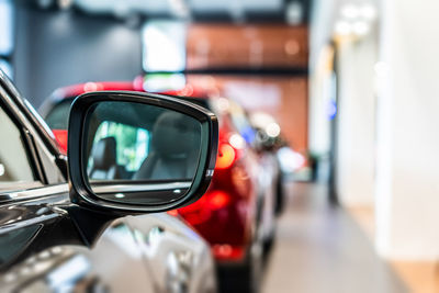 Close-up of sunglasses on side-view mirror