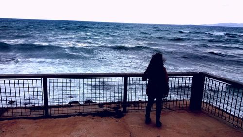 Man on beach against clear sky