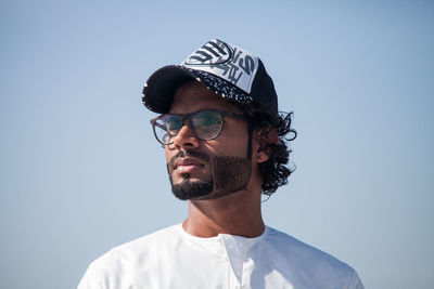 Portrait of man wearing sunglasses against sky