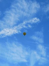 Low angle view of hot air balloon against blue sky