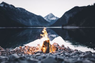 Close-up of bonfire against mountain