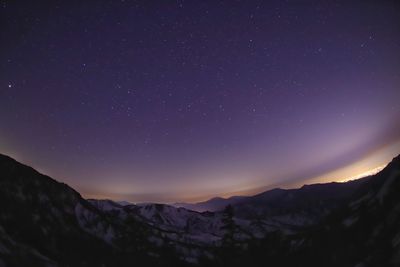 Scenic view of mountains against sky at night