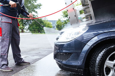 Low section of man standing in car