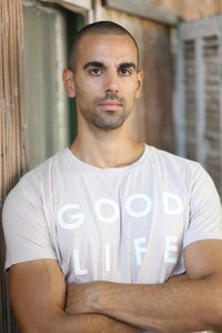 Portrait of young man with arms crossed