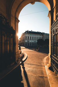 City street by building against clear sky