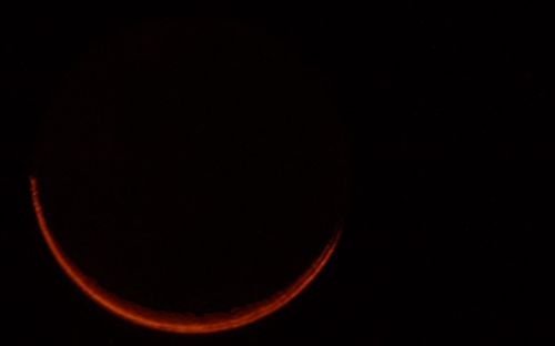 Low angle view of moon against clear sky at night