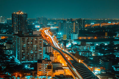 High angle view of illuminated buildings in city at night