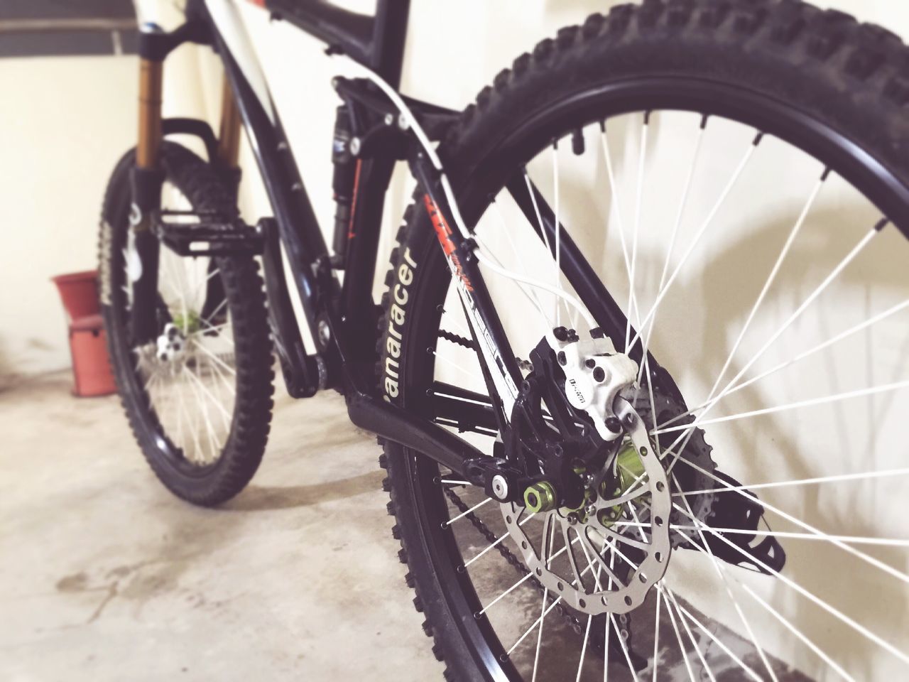 bicycle, transportation, land vehicle, mode of transport, wheel, stationary, parking, parked, no people, outdoors, day, street, close-up, tire, plant, part of, cropped, flower, sunlight, leaning