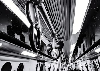 Low angle view of illuminated lighting equipment on city