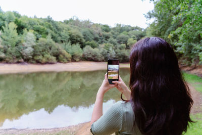 Woman photographing with mobile phone