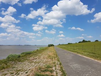 Road by land against sky