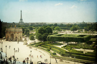 Panoramic view of tourists on landscape against sky