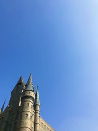 Low angle view of building against clear blue sky