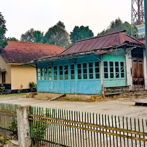 House by building against clear sky