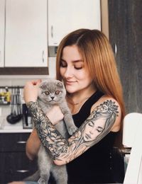 Portrait of smiling young woman with cat