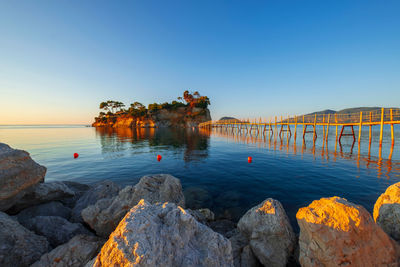 Scenic view of sea against clear blue sky