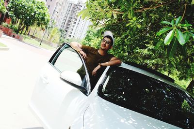 Portrait of smiling young man in car