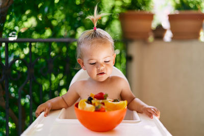 Girl with food in bowl