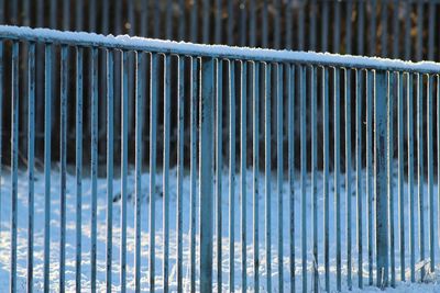 Close-up of frozen metallic railing during winter