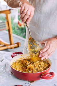 Cropped hand of person preparing food