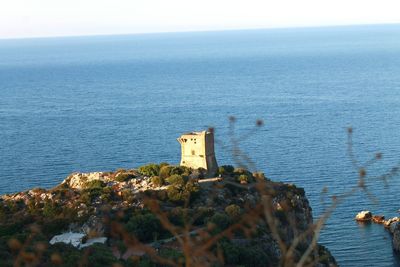 High angle view of building by sea against sky