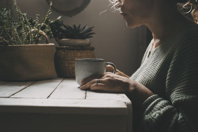 Young woman using mobile phone while sitting at home