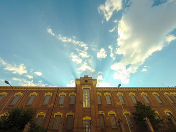 Low angle view of building against cloudy sky