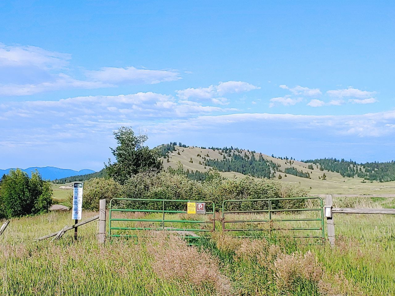 WOODEN FENCE ON FIELD AGAINST SKY