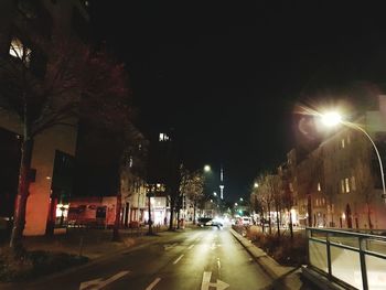 Illuminated city street at night