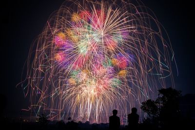 Low angle view of firework display at night